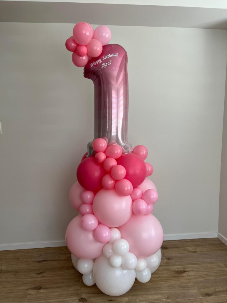 Pink first birthday balloon decor