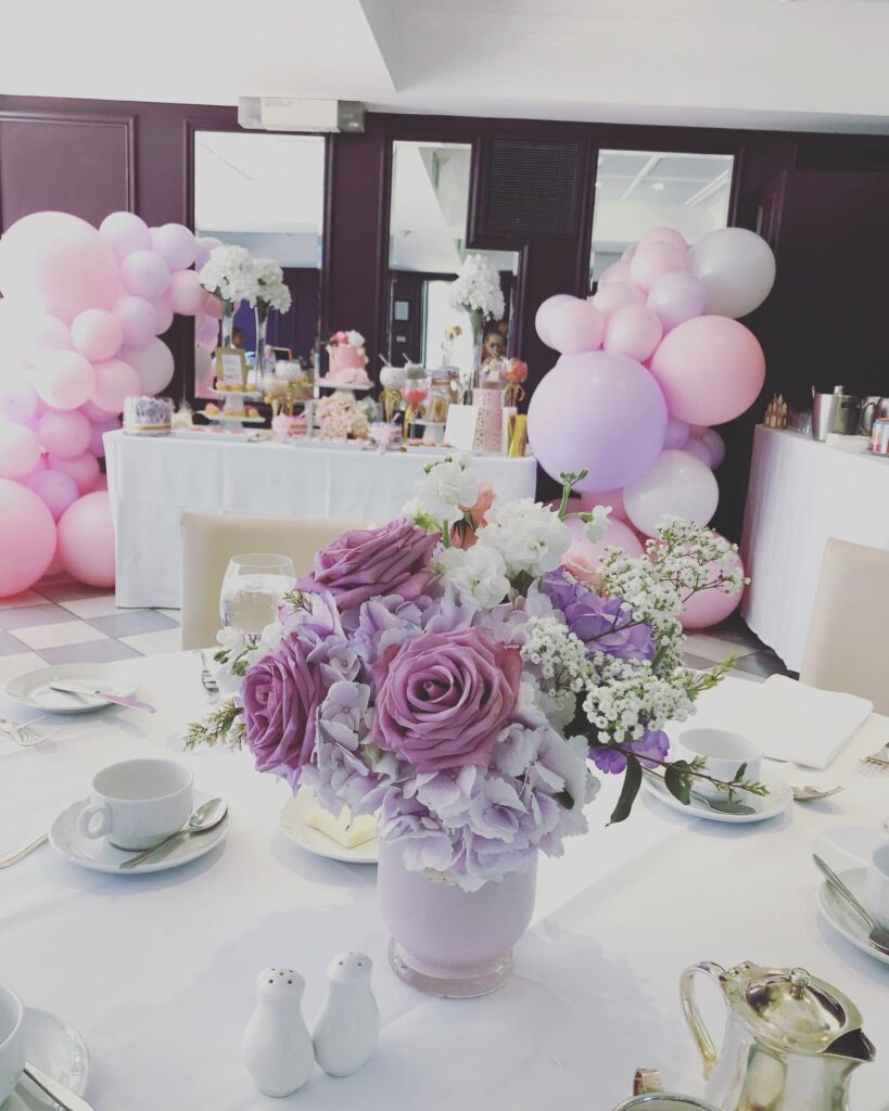 pink balloon arch with lavender flower centerpiece