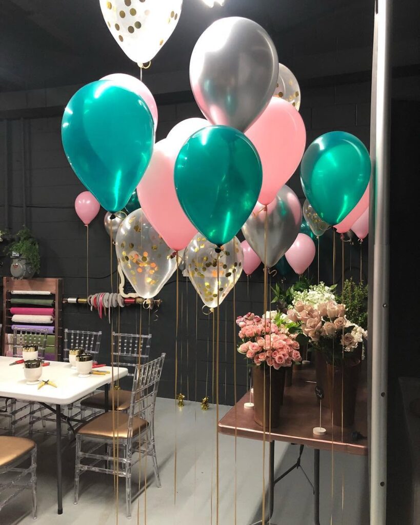 teal pink balloons and rose flower display